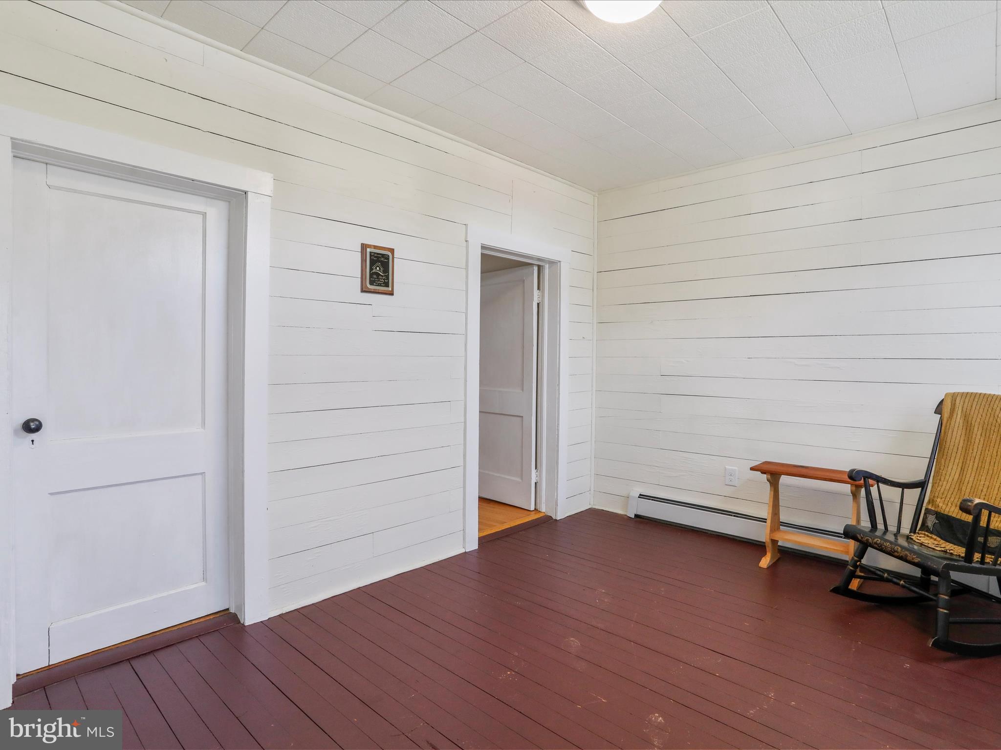 8610 Fort Valley Road Fort Valley, VA 22652 - Photo 14 of 61 an empty room with wooden floor and lounge chair