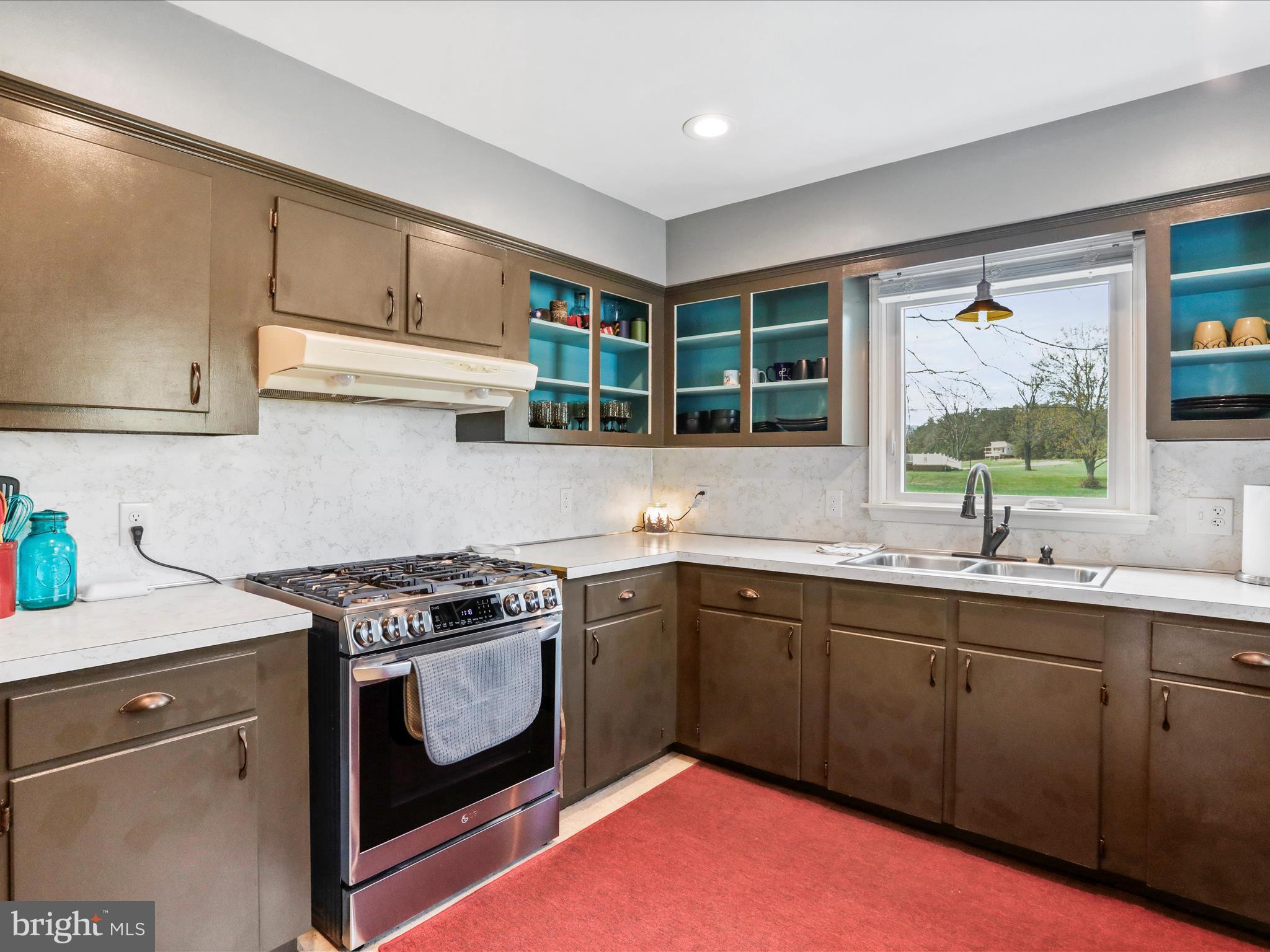 8610 Fort Valley Road Fort Valley, VA 22652 - Photo 22 of 61 a kitchen with a stove sink and cabinets