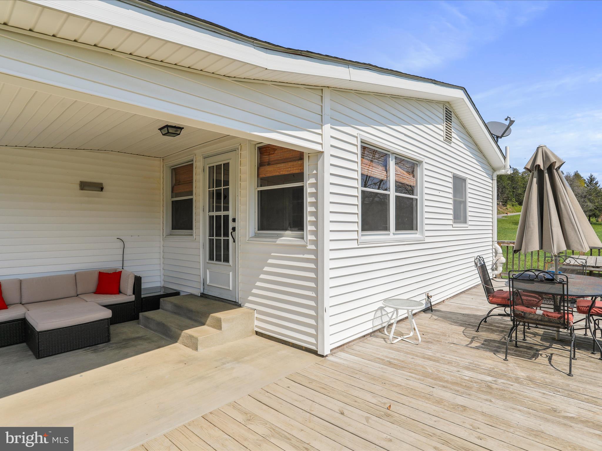 8610 Fort Valley Road Fort Valley, VA 22652 - Photo 6 of 61 a view of a patio with table and chairs with wooden floor and fence