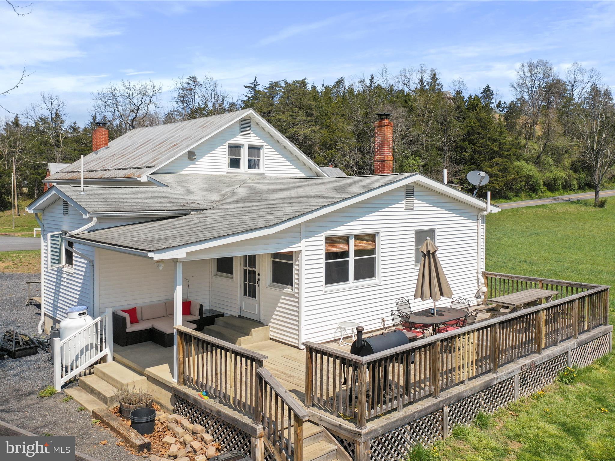 8610 Fort Valley Road Fort Valley, VA 22652 - Photo 10 of 61 a view of a house with wooden deck and furniture