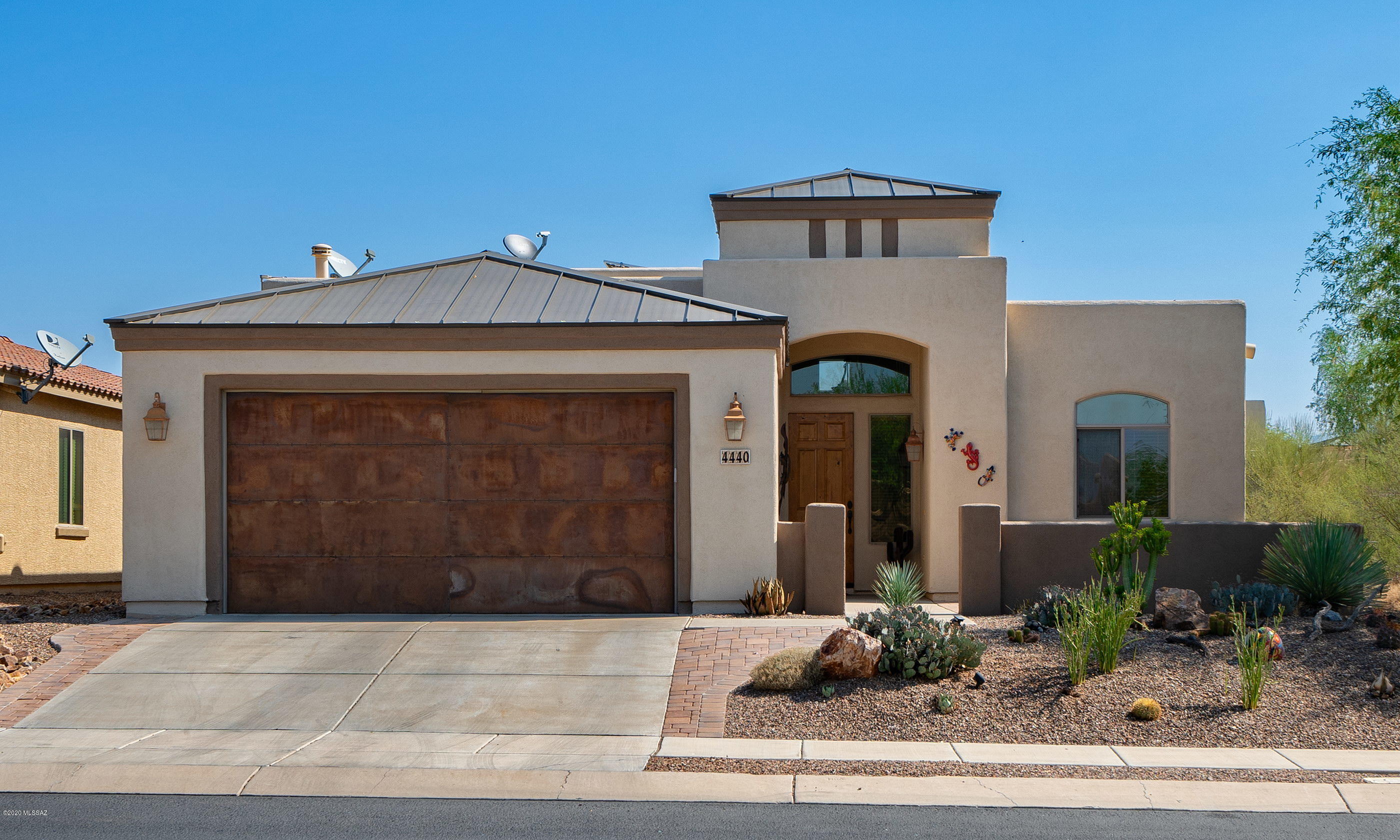 4440 West Crystal Ranch Place Marana, AZ 85658 - Photo 1 of 28 a front view of a house with garden