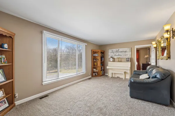 a bedroom with a bed and a flat tv screen on dresser
