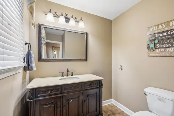 a bedroom with a bed and a mirror on dresser