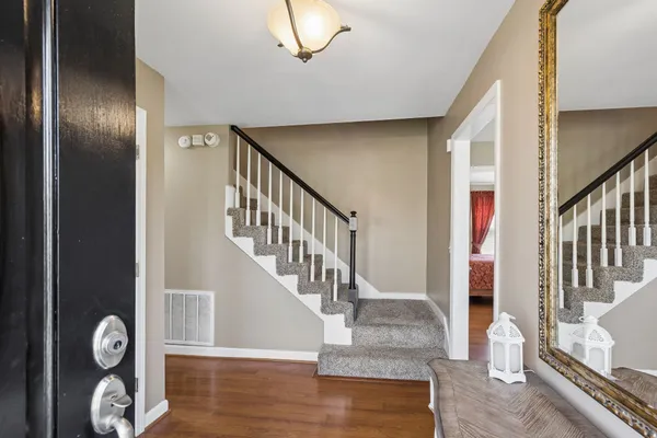 a bedroom with a bed a baby crib and a chandelier