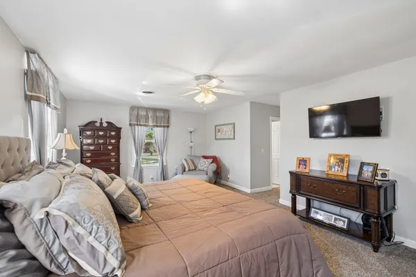 a bedroom with a bed and a dresser