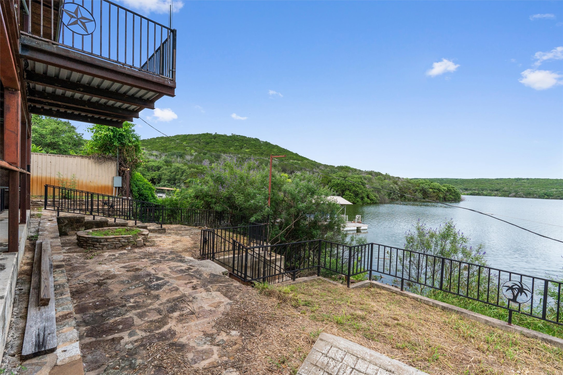 325 Eagle Rest Burnet, TX 78611 - Photo 38 of 40 Perched above the lake, this outdoor terrace offers a serene vista with direct water access and lush hillside views.