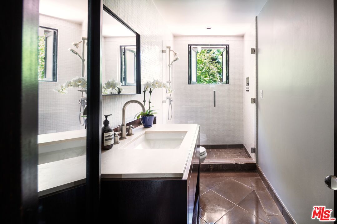 6464 Bryn Mawr Drive Los Angeles, CA 90068 - Photo 15 of 23 a bathroom with a sink and a mirror