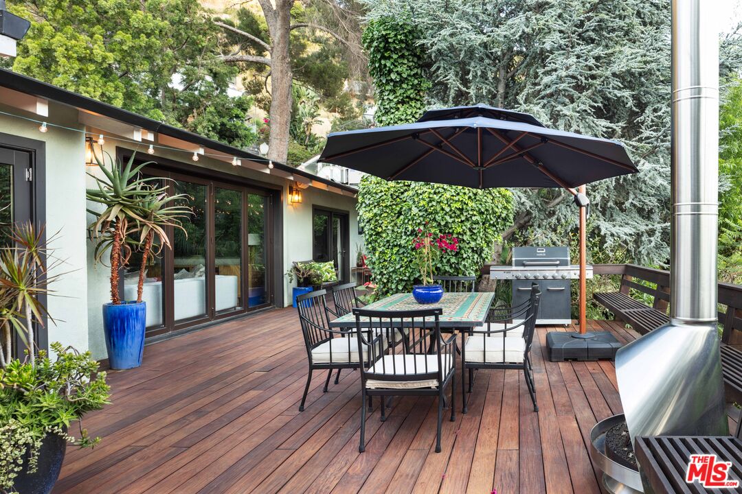 6464 Bryn Mawr Drive Los Angeles, CA 90068 - Photo 19 of 23 a view of a chairs and table under an umbrella in patio