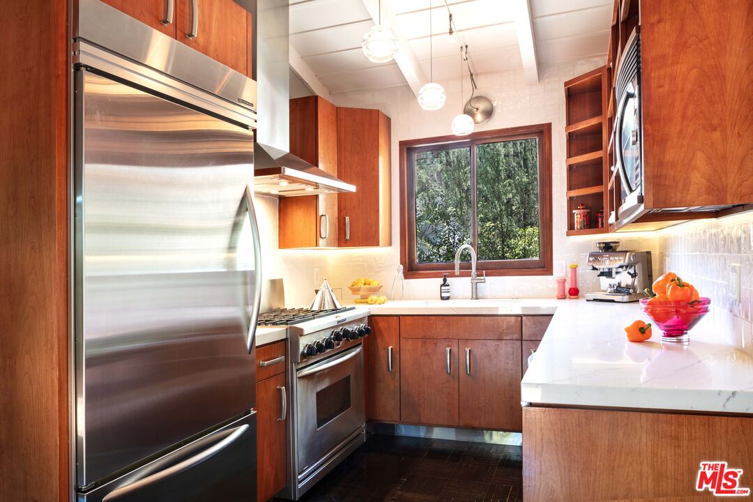 6464 Bryn Mawr Drive Los Angeles, CA 90068 - Photo 10 of 23 a kitchen with stainless steel appliances granite countertop a sink and a refrigerator