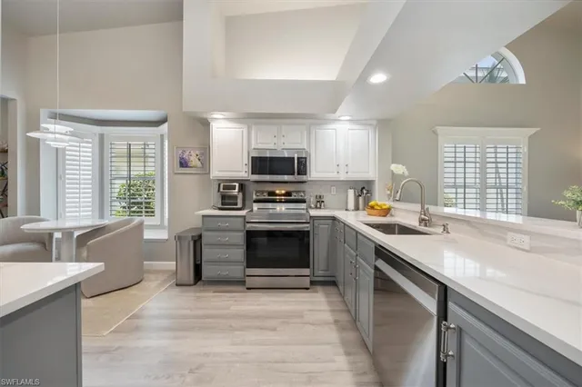 a kitchen with a stove a sink and a microwave