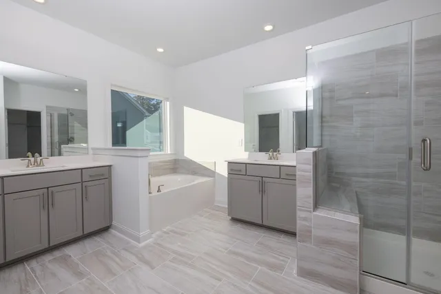 a bathroom with a shower sink and mirror