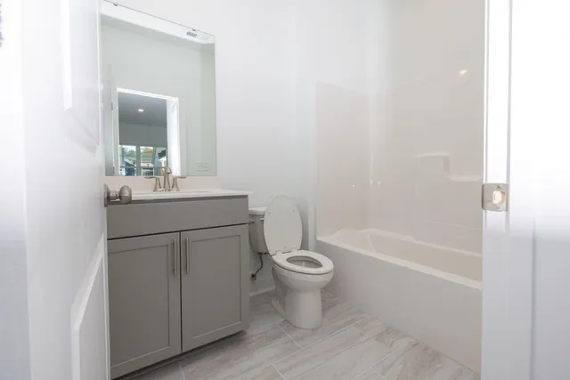 a dining room with furniture and a floor to ceiling window
