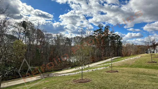 a living room with fireplace furniture and large windows