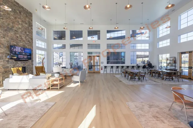 a living room with furniture a large window and potted plants