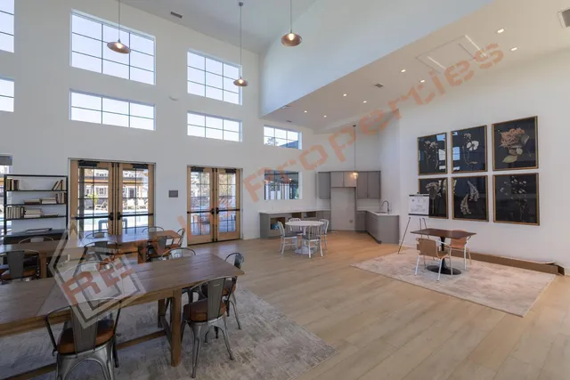 a view of a bedroom with furniture and large windows