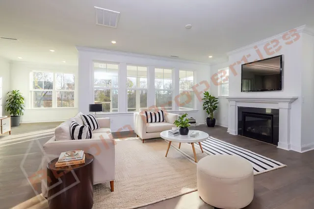 a view of an empty room with a fireplace and a window