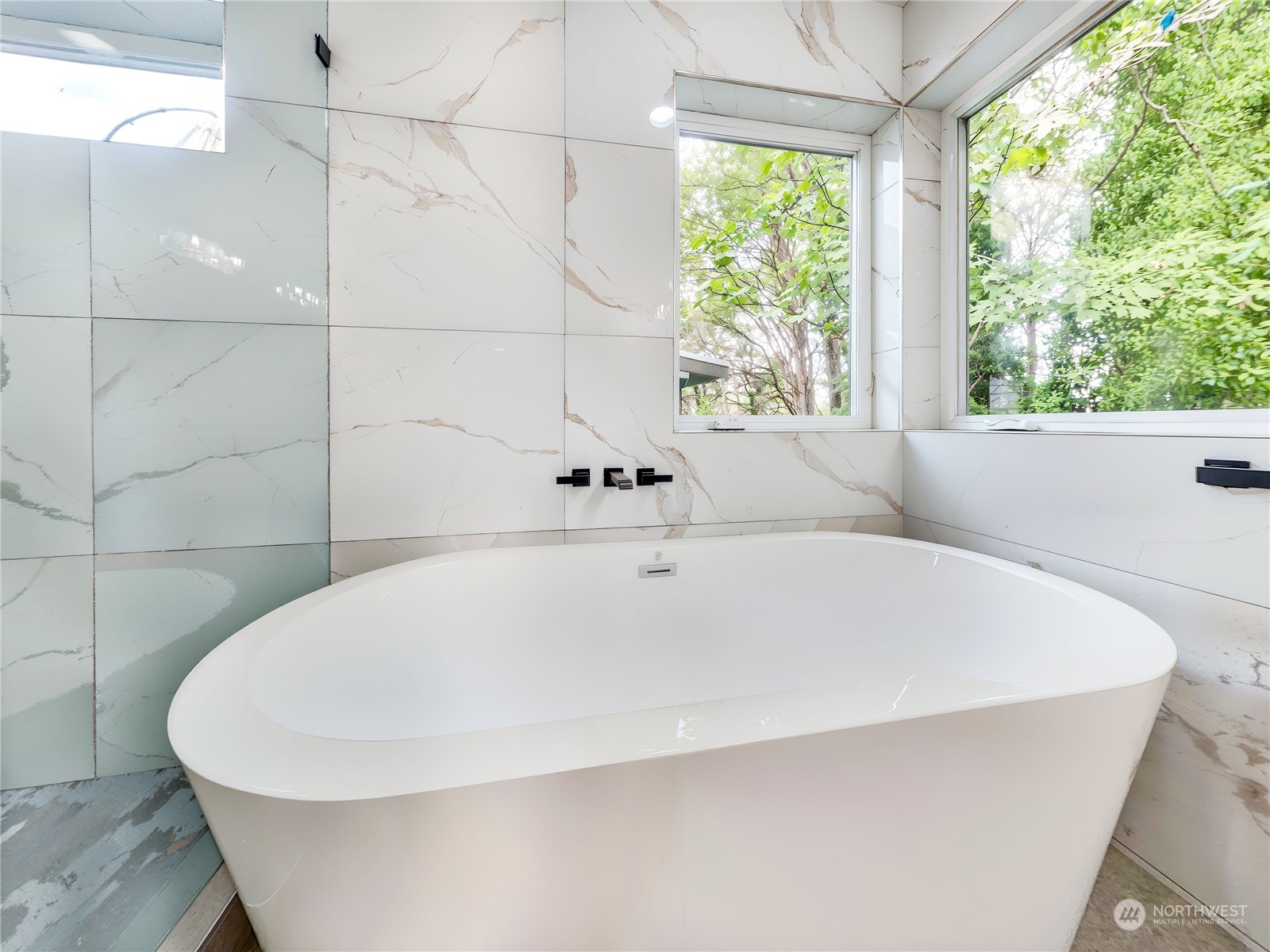 407 Southwest Thistle Street Seattle, WA 98106 - Photo 22 of 40 a white bath tub sitting in a bathroom next to a window