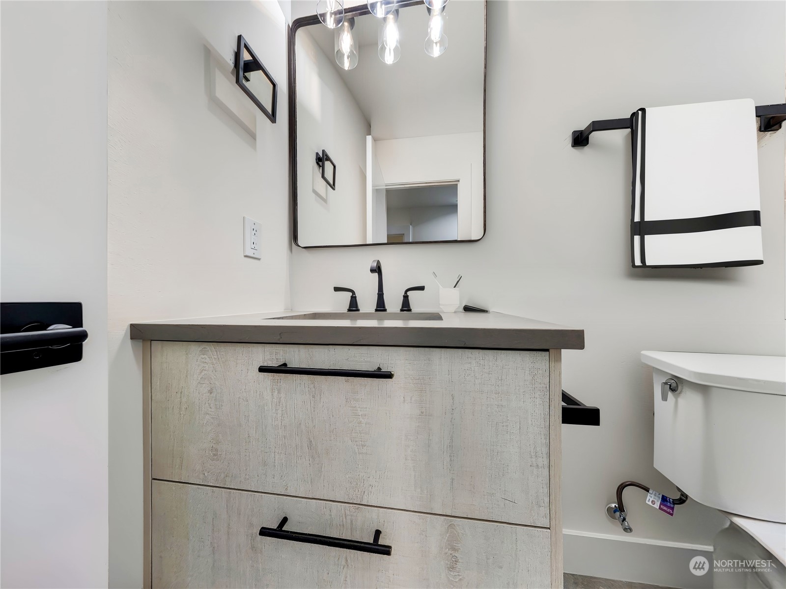 407 Southwest Thistle Street Seattle, WA 98106 - Photo 26 of 40 a bathroom with a sink and a mirror