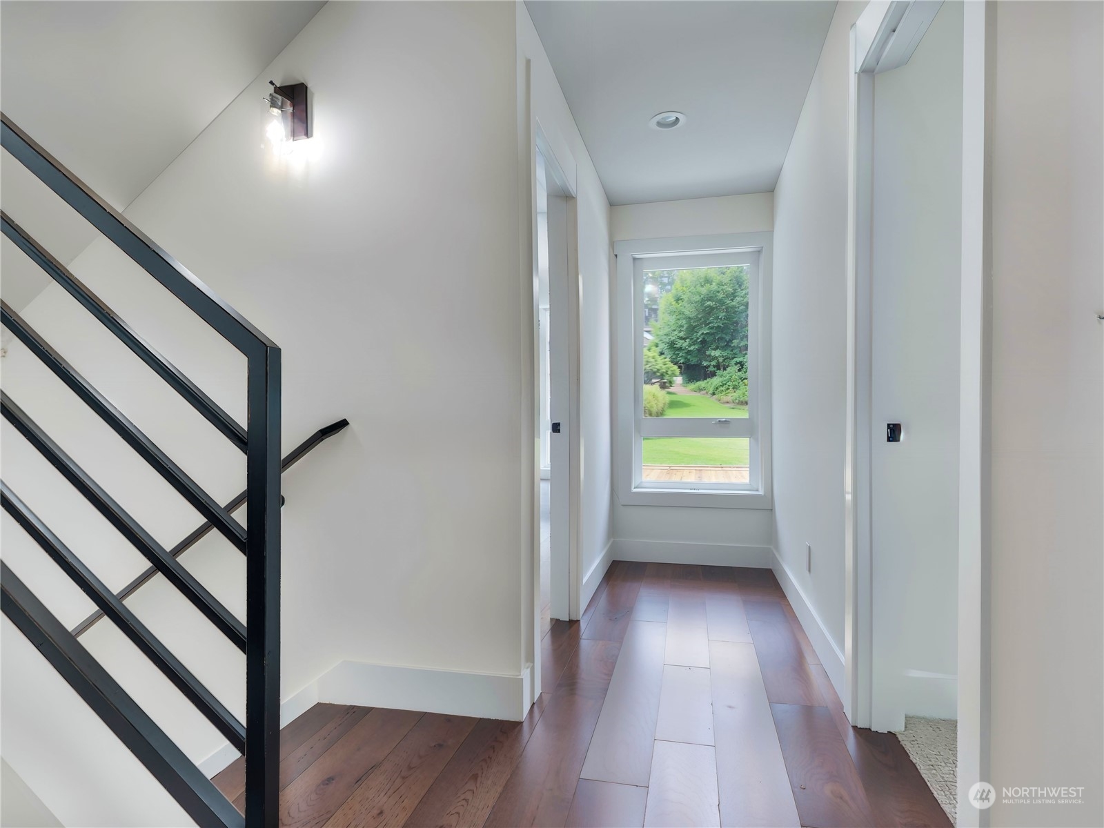 407 Southwest Thistle Street Seattle, WA 98106 - Photo 30 of 40 a view of a hallway with wooden floor and stairs
