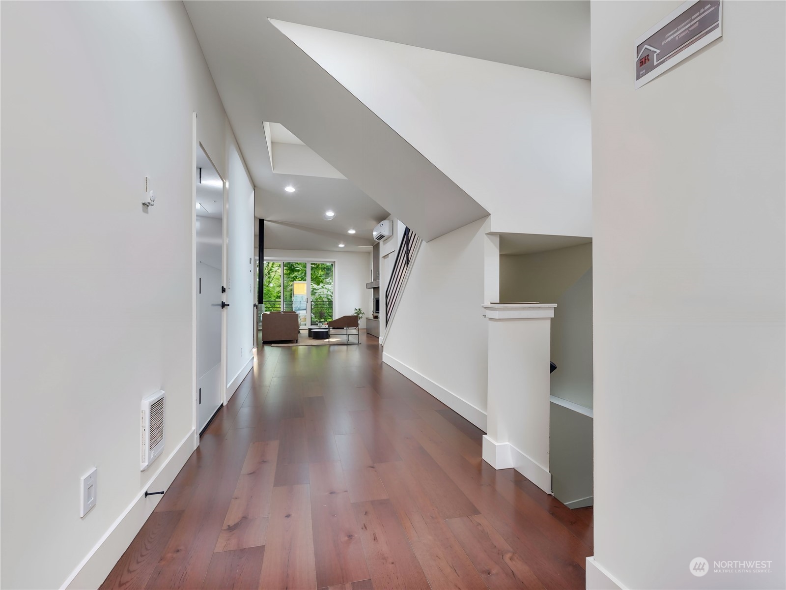 407 Southwest Thistle Street Seattle, WA 98106 - Photo 31 of 40 a view of a hallway view with wooden floor and a living room