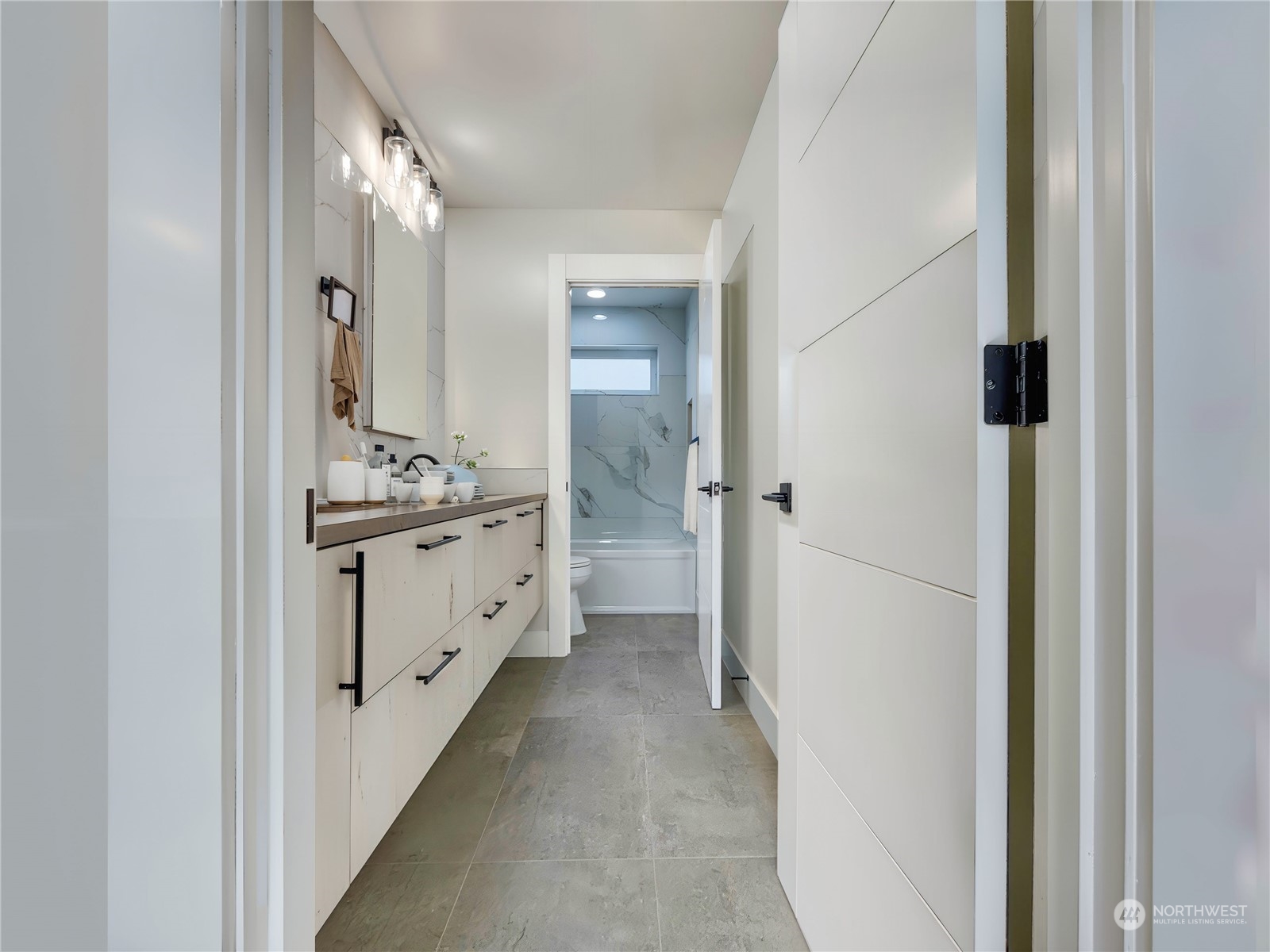 407 Southwest Thistle Street Seattle, WA 98106 - Photo 32 of 40 a bathroom with a sink a mirror and a shower