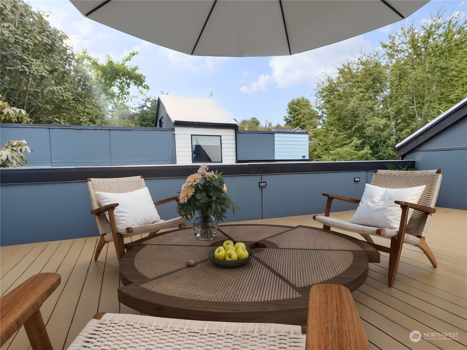 407 Southwest Thistle Street Seattle, WA 98106 - Photo 34 of 40 a view of a patio with table and chairs under an umbrella with a sink