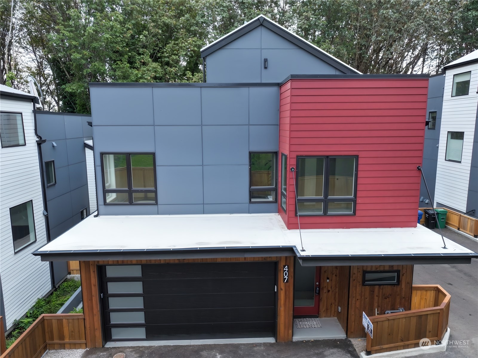 407 Southwest Thistle Street Seattle, WA 98106 - Photo 4 of 40 a front view of a house with garage