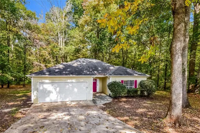 a front view of house with yard and trees
