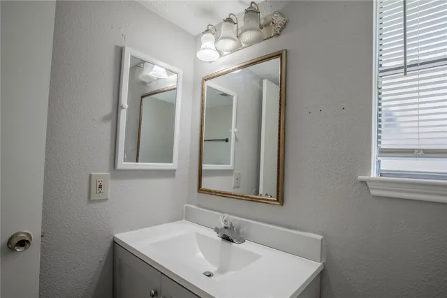 a bathroom with a double vanity sink and a mirror