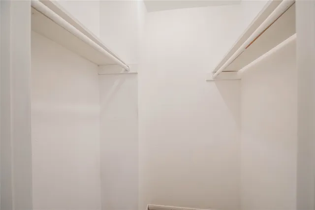 a view of a backyard with a fence and trees