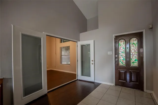 a view of a small space with wooden floor and a window