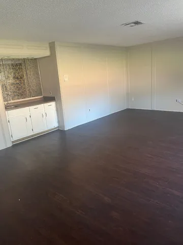 an empty room with windows and entrance