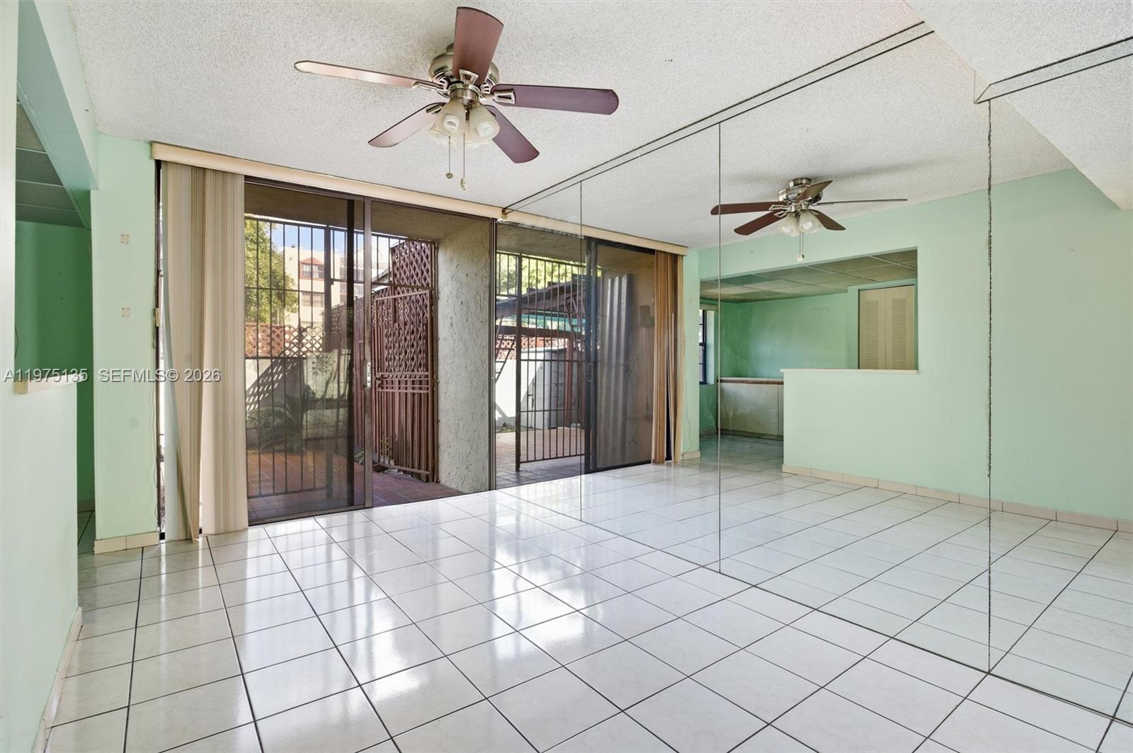 12253 Southwest 16th Terrace, Unit 108M Miami, FL 33175 - Photo 13 of 50 a spacious bathroom with a mirror and a shower