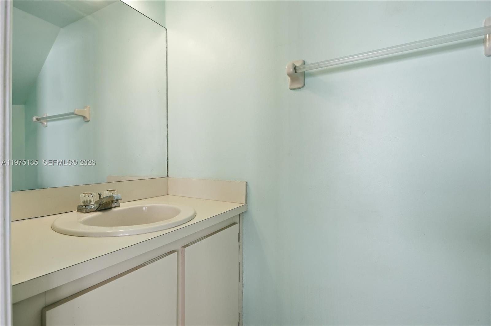 12253 Southwest 16th Terrace, Unit 108M Miami, FL 33175 - Photo 20 of 50 a bathroom with a sink and a mirror