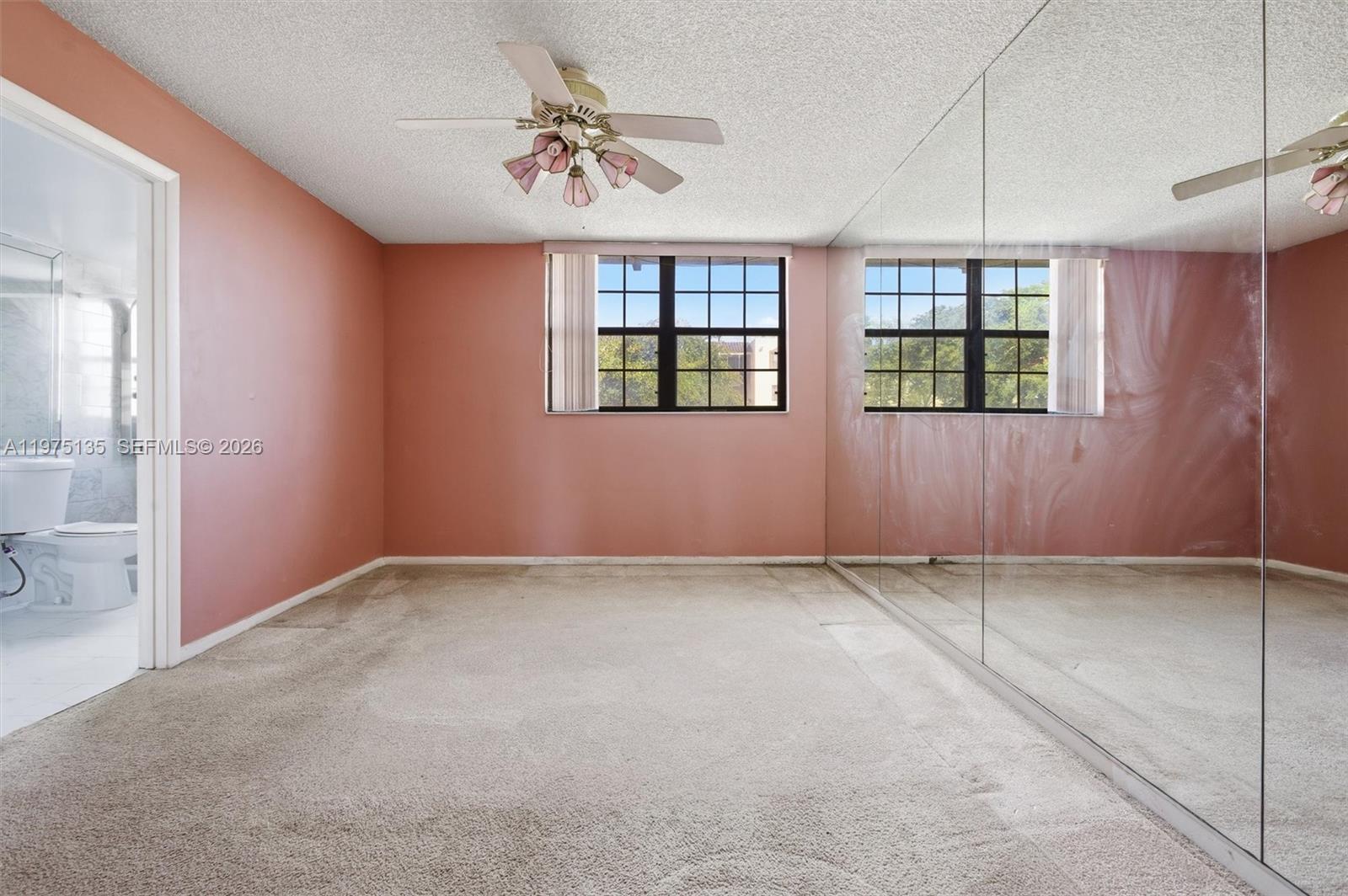 12253 Southwest 16th Terrace, Unit 108M Miami, FL 33175 - Photo 26 of 50 an empty room with windows and closet