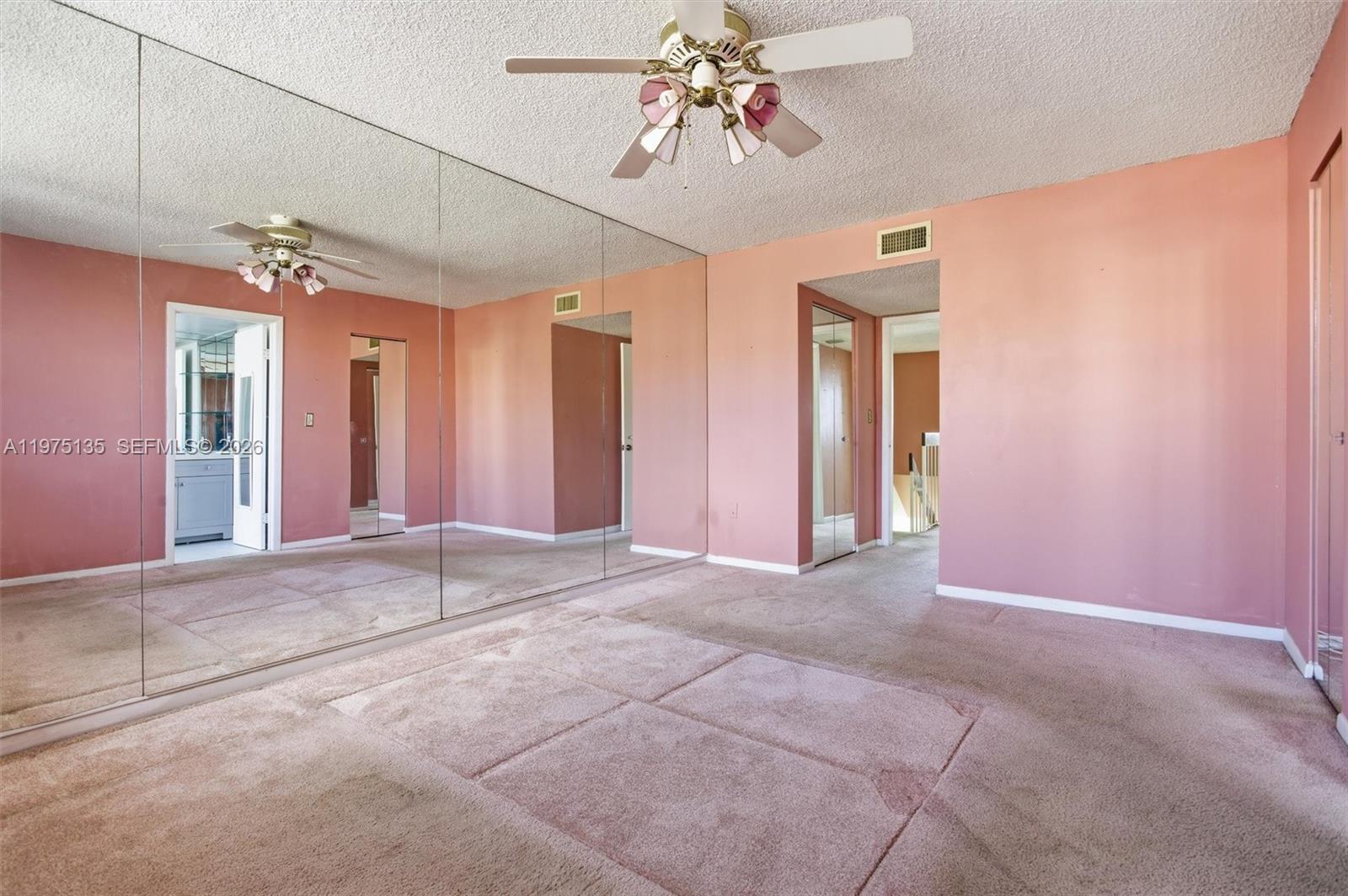 12253 Southwest 16th Terrace, Unit 108M Miami, FL 33175 - Photo 28 of 50 a view of a livingroom with a chandelier fan and windows