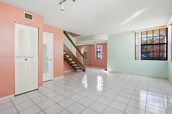 a view of an empty room with windows