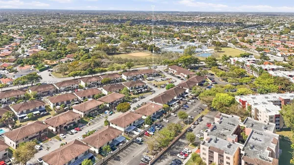 an aerial view of residential houses with outdoor space