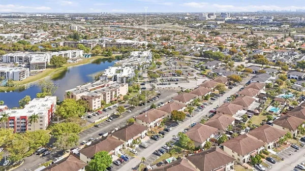 an aerial view of lake and residential houses with outdoor space