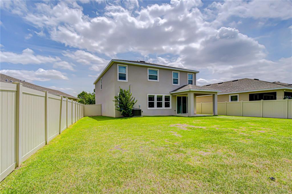 16607 Goose Ribbon Place Wimauma, FL 33598 - Photo 31 of 35 a front view of a house with garden