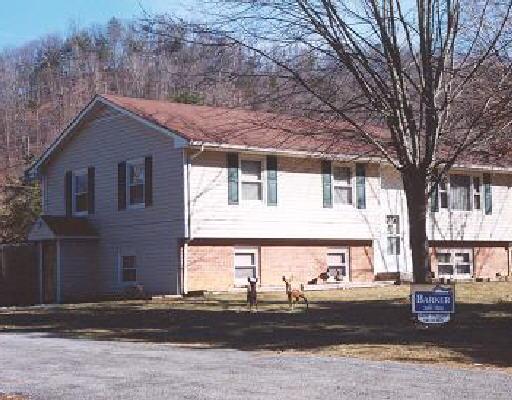 5204 Maxey Road Elliston, VA 24087 - Photo 1 of 1 a front view of a house with a yard and garage