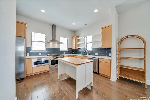 a kitchen with stainless steel appliances granite countertop a stove and a sink