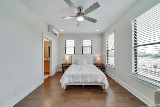 a bedroom with furniture and a ceiling fan