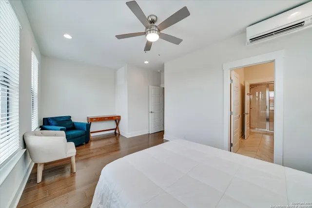 a bathroom with a sink double vanity granite tub shower and a mirror