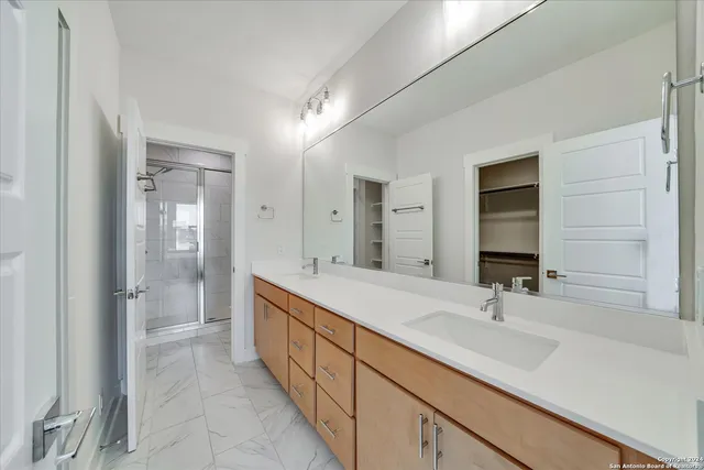 a bathroom with a glass shower door
