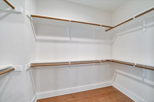 a spacious bedroom with a bed and a window