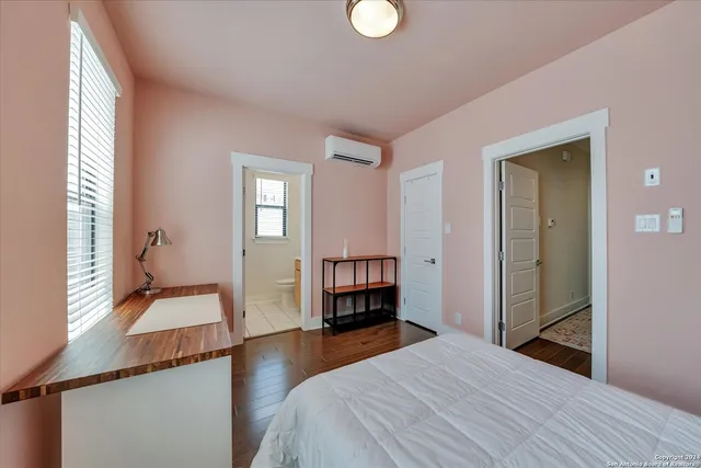 a bathroom with a granite countertop sink toilet and a mirror