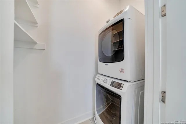 a view of an empty room with a ceiling fan