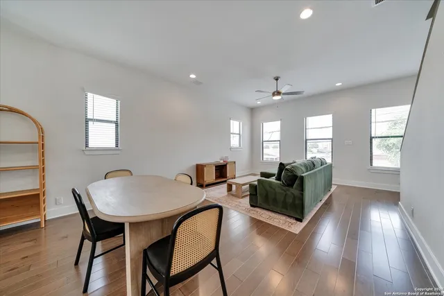 a view of a dining room with furniture and wooden floor
