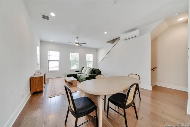 a living room with furniture and kitchen view